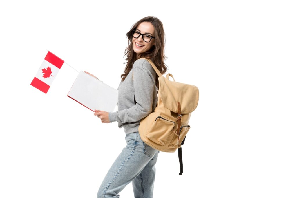 happy female student with backpack holding canadian flag and notebook isolated on white