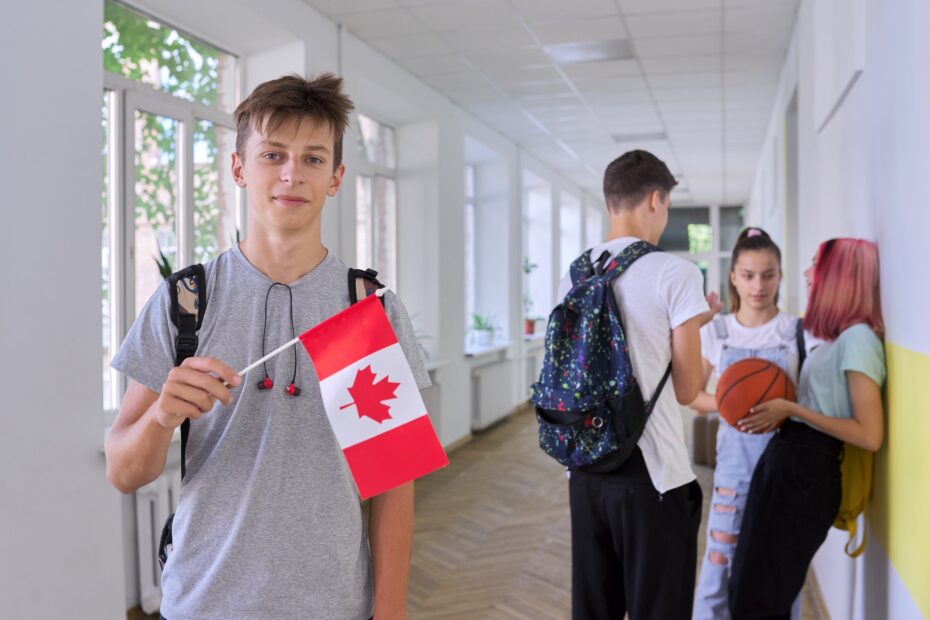 Student teenager male with flag of Canada inside school