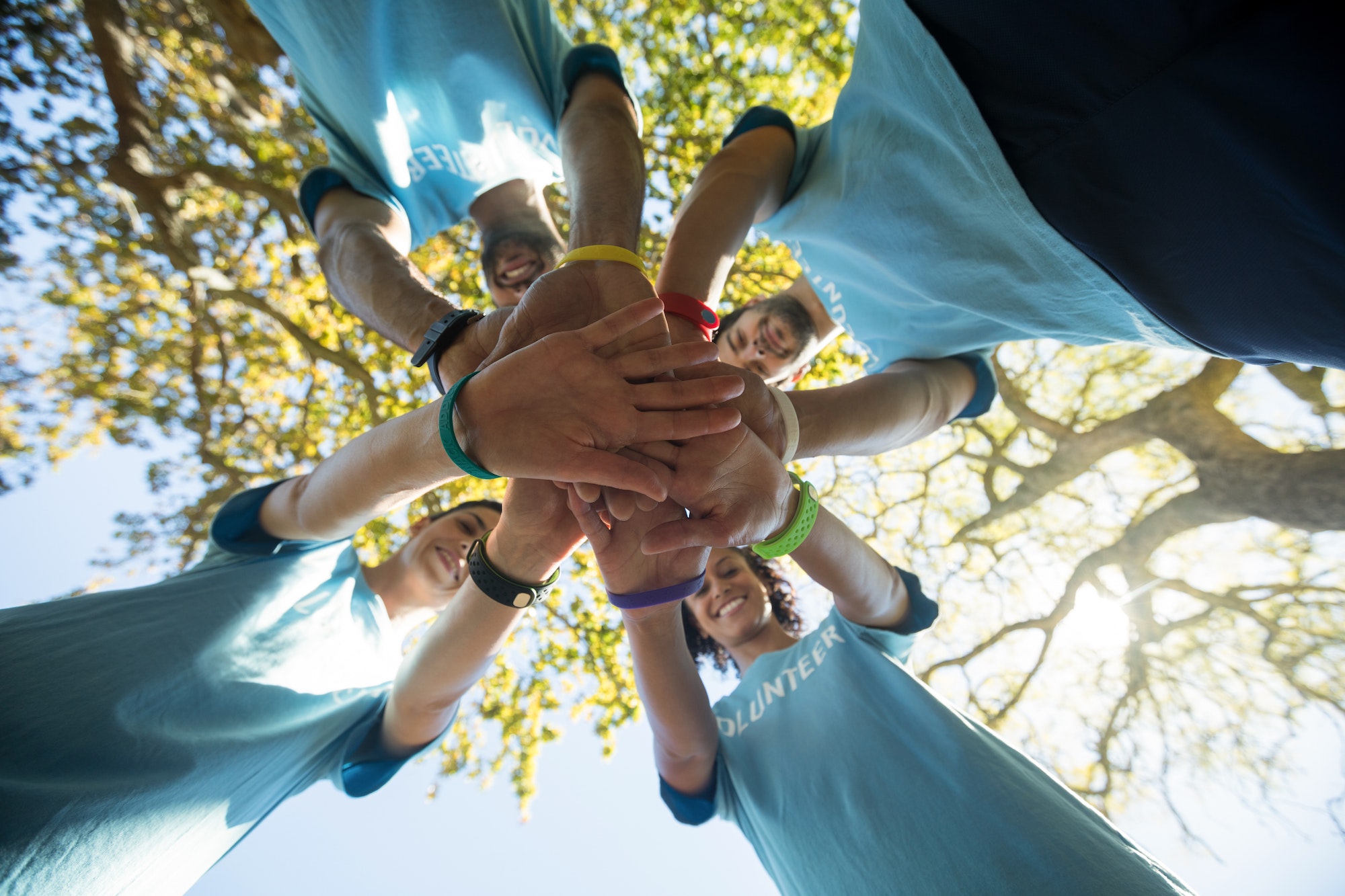 Volunteers forming a hand stack in the park